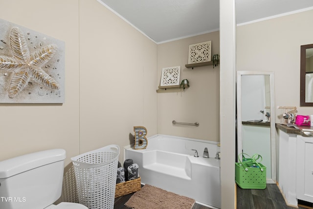 bathroom featuring a garden tub, crown molding, toilet, and wood finished floors