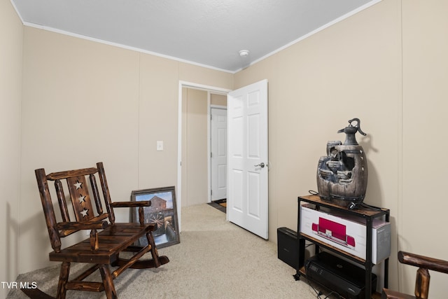 sitting room featuring crown molding and light colored carpet