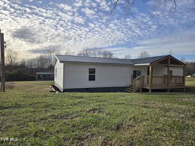 exterior space featuring a deck, metal roof, crawl space, and a lawn