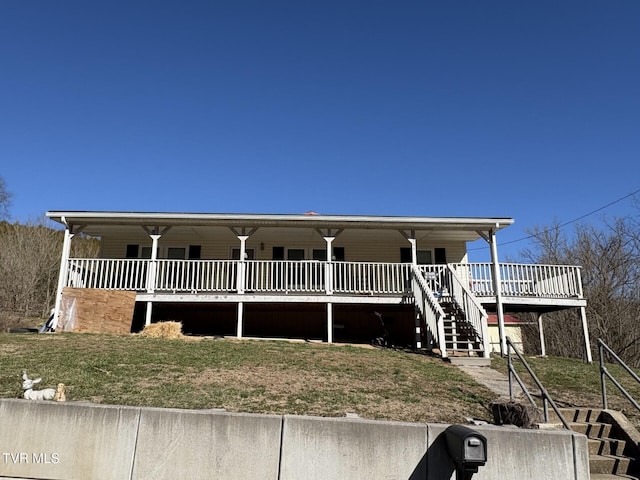 view of front of property with stairway, a porch, and a front yard