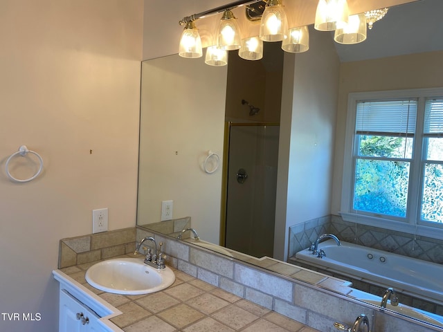 bathroom featuring a stall shower, a jetted tub, and vanity