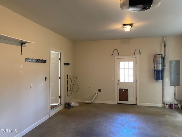 garage featuring baseboards, electric panel, and a garage door opener