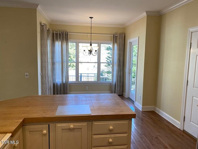 kitchen featuring a notable chandelier, dark wood-type flooring, wooden counters, ornamental molding, and pendant lighting