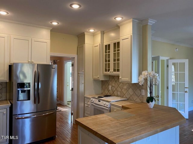 kitchen with electric range, butcher block countertops, ornamental molding, dark wood-type flooring, and stainless steel refrigerator with ice dispenser