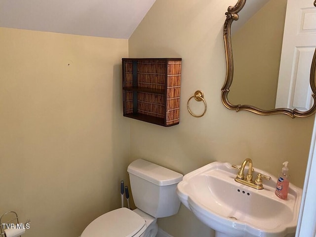 half bathroom featuring a sink and toilet