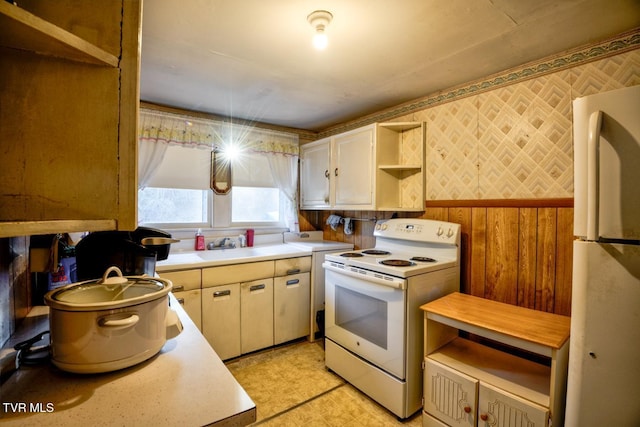 kitchen featuring white appliances, wallpapered walls, light countertops, light floors, and open shelves