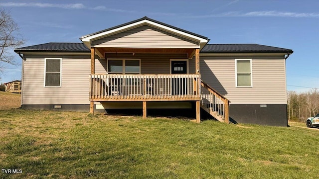 back of house featuring crawl space, covered porch, metal roof, and a yard