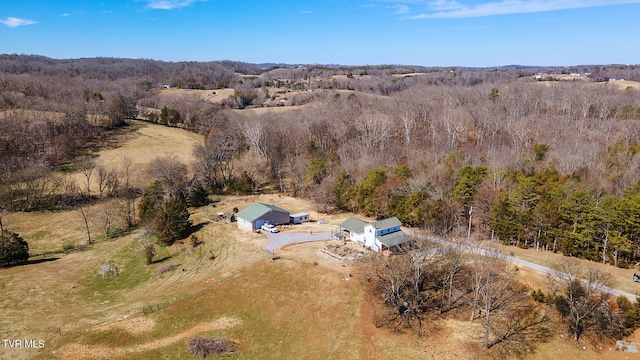 drone / aerial view featuring a view of trees