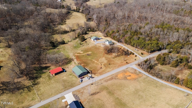 drone / aerial view with a wooded view