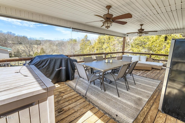 deck featuring outdoor dining area and a ceiling fan