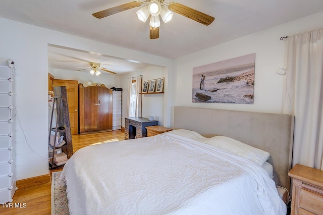 bedroom with light wood-style floors and ceiling fan