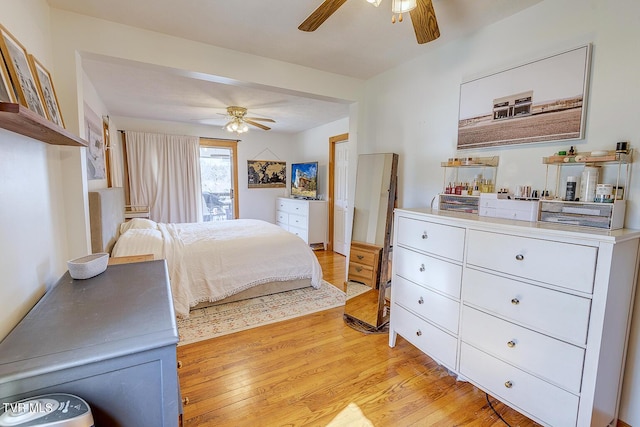 bedroom with a ceiling fan and light wood-style flooring