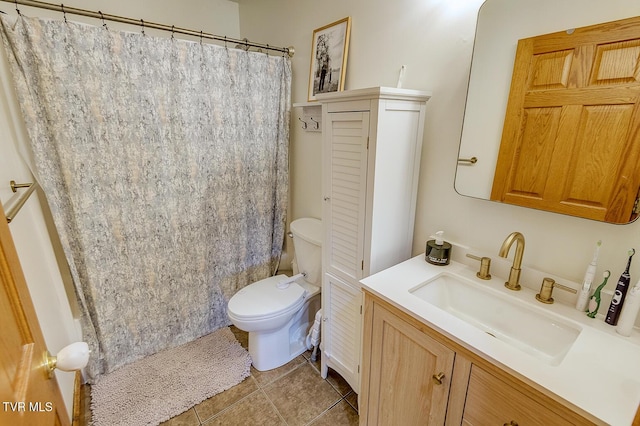 bathroom with toilet, a shower with curtain, vanity, and tile patterned floors