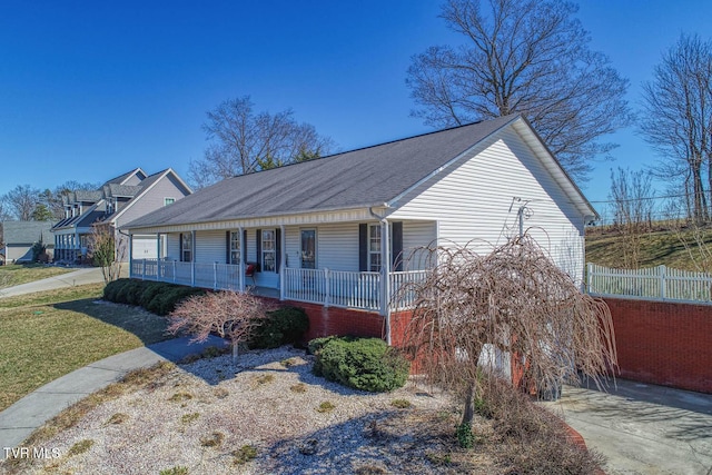 view of front of house featuring covered porch and fence