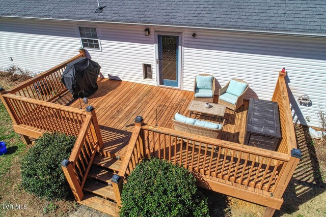 wooden terrace featuring a grill