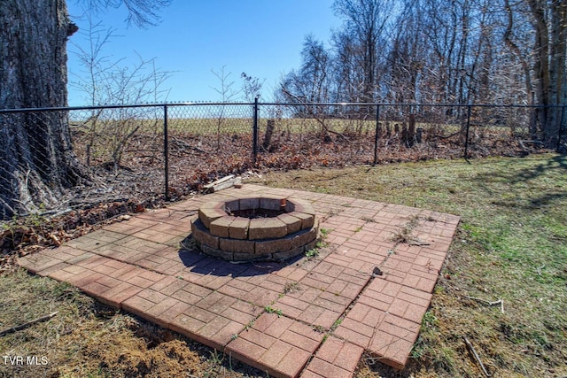 view of patio / terrace with fence and a fire pit