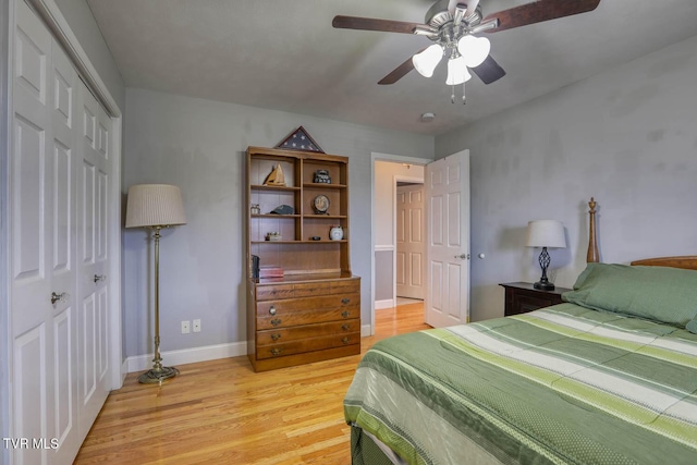 bedroom featuring a closet, baseboards, ceiling fan, and light wood finished floors