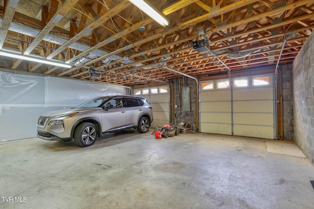 garage featuring a garage door opener and electric panel