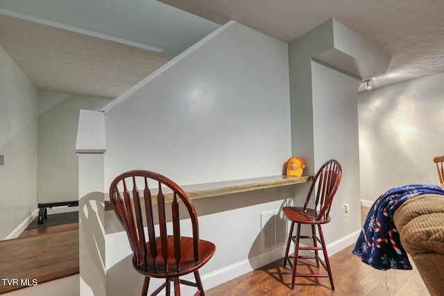 interior space with baseboards and wood finished floors