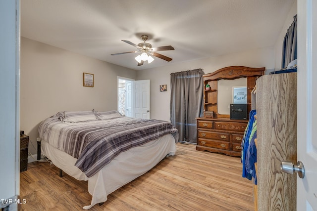 bedroom featuring light wood finished floors and ceiling fan