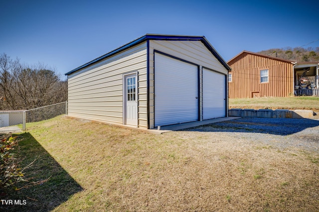 view of outbuilding with fence and an outdoor structure