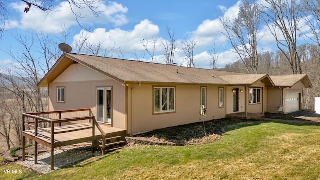 back of property with a garage, roof with shingles, a lawn, and a wooden deck