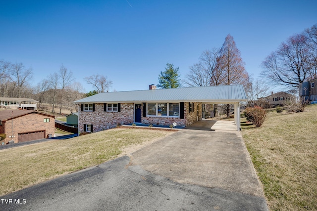 view of front of house with driveway, metal roof, a chimney, and a front lawn