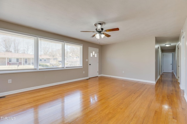 unfurnished living room featuring ceiling fan, visible vents, light wood-style flooring, and baseboards