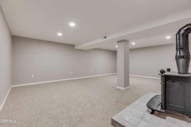 finished below grade area featuring recessed lighting, light colored carpet, visible vents, and baseboards