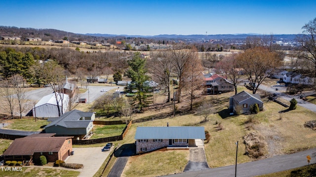 drone / aerial view featuring a residential view and a mountain view