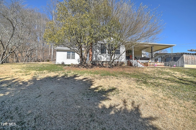 view of front of property featuring a carport and a front lawn