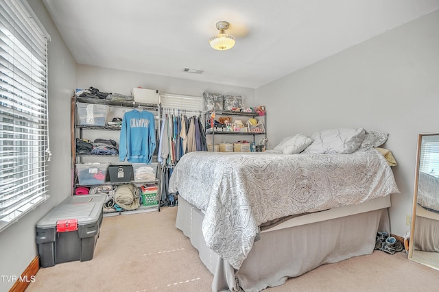 carpeted bedroom featuring visible vents