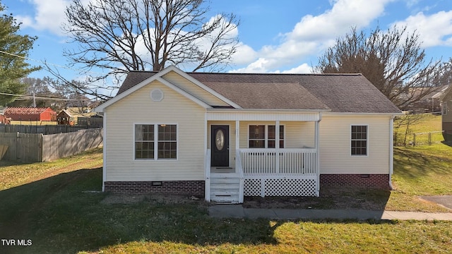 bungalow-style house featuring a shingled roof, covered porch, a front yard, crawl space, and fence