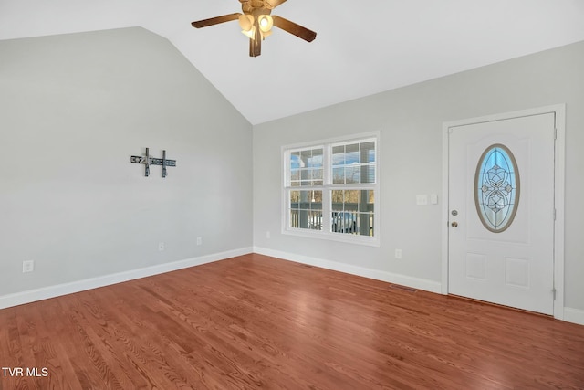 foyer entrance featuring ceiling fan, vaulted ceiling, baseboards, and wood finished floors