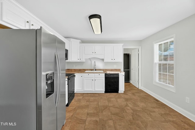 kitchen featuring black appliances, white cabinets, a sink, and light countertops