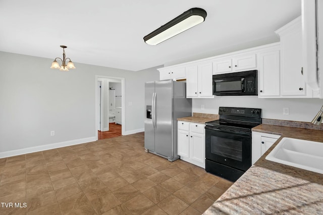 kitchen with hanging light fixtures, white cabinets, a sink, black appliances, and baseboards