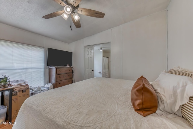 bedroom featuring a ceiling fan and a textured ceiling