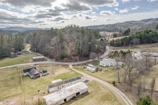 aerial view featuring a mountain view, a wooded view, and a rural view