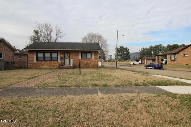 view of front of property featuring brick siding and a front yard