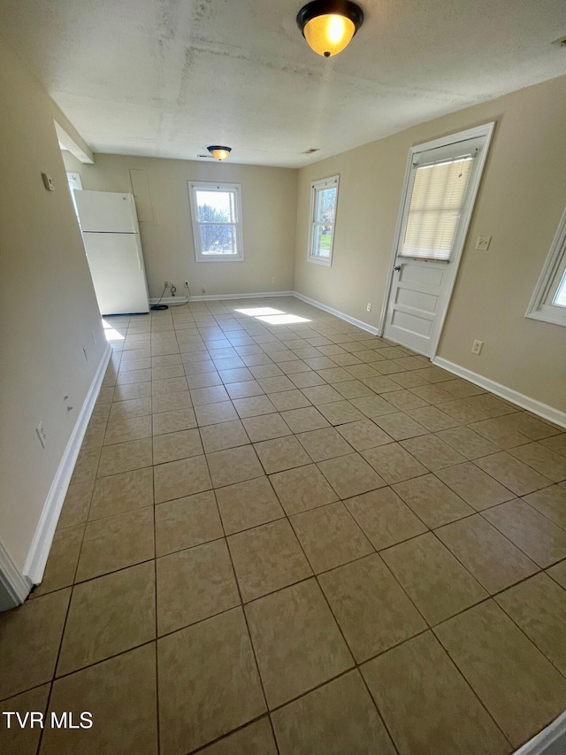 tiled empty room with baseboards