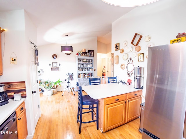 5659 Browning Way, Russellville, TN 37860 - kitchen with lofted ceiling, light countertops, a breakfast bar area, and freestanding refrigerator