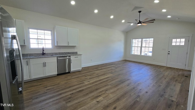 kitchen featuring dark wood-style floors, stainless steel appliances, open floor plan, white cabinets, and a sink