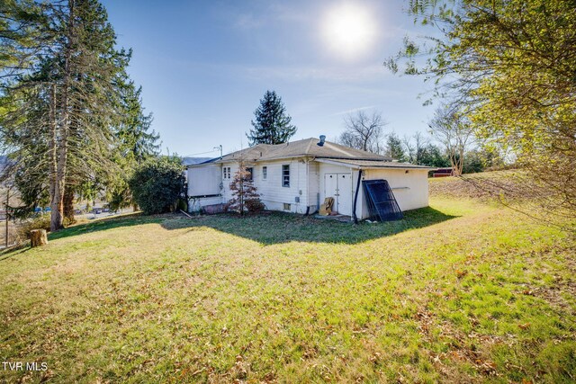 rear view of house with a yard