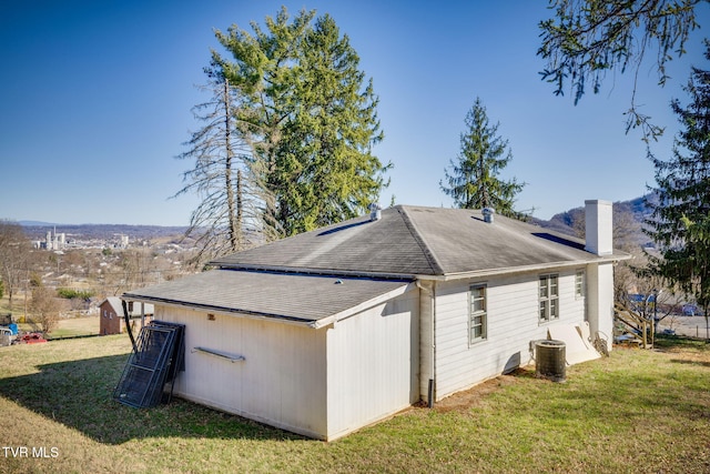 view of property exterior with central AC, a yard, and a chimney