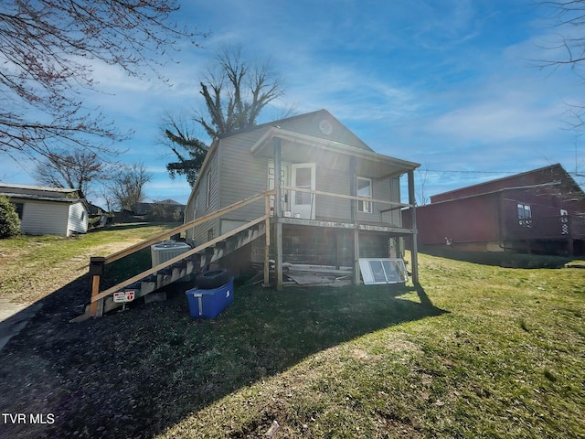 back of property featuring a lawn