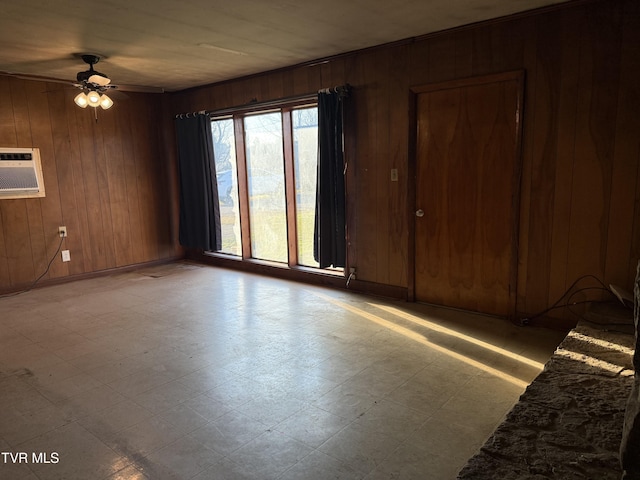 spare room with an AC wall unit, wood walls, and tile patterned floors