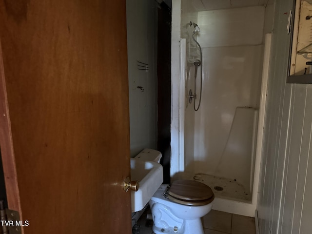 full bathroom with tile patterned flooring, a shower stall, and toilet