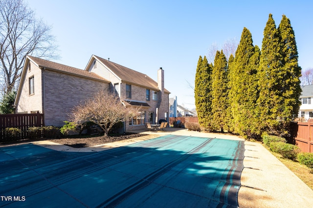 view of pool featuring a patio area, a fenced backyard, and a fenced in pool