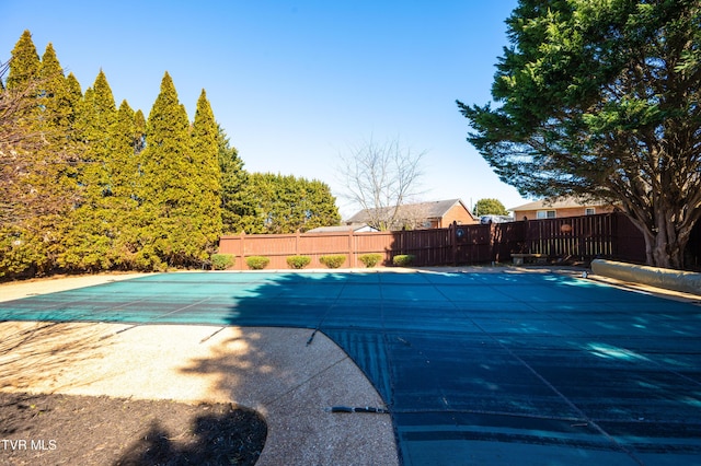 view of swimming pool featuring a patio, fence, and a fenced in pool