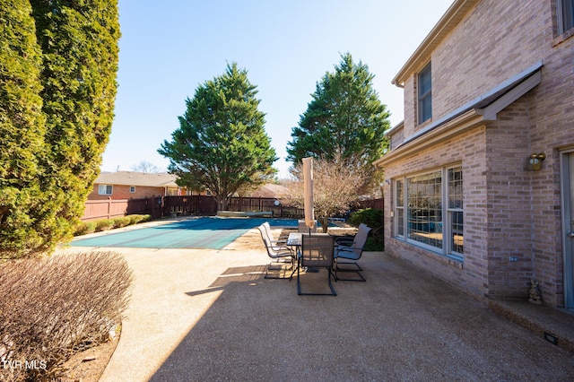 view of pool with a fenced in pool, a patio area, and fence